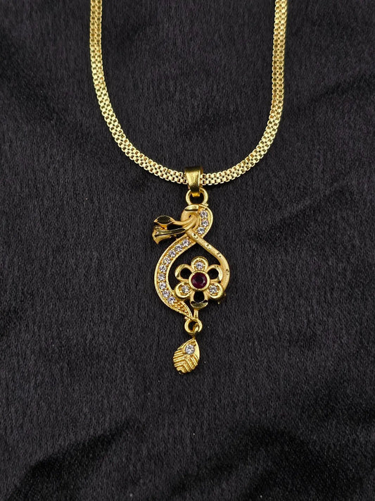 Gold necklace with a decorative pendant on a black background