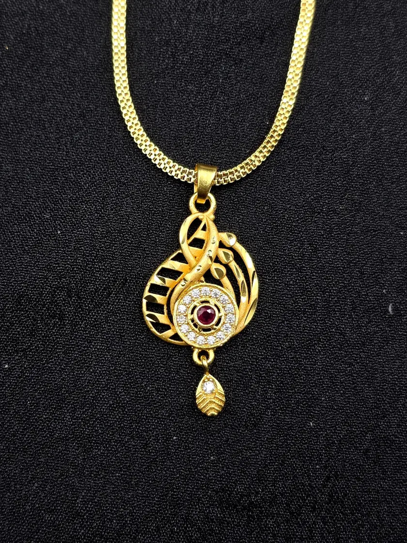 Gold necklace with a decorative pendant on a black background