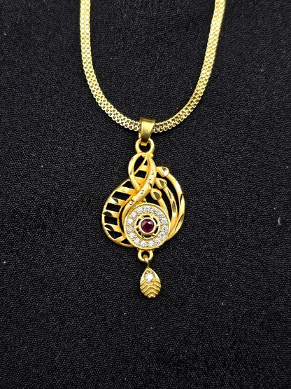 Gold necklace with a decorative pendant on a black background