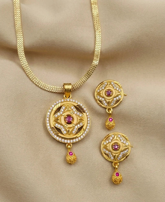 Gold necklace with matching earrings on a beige background