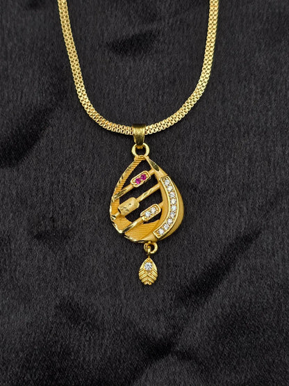 Gold necklace with a pendant on a black fabric background