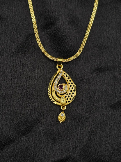 Gold necklace with a pendant on a black fabric background