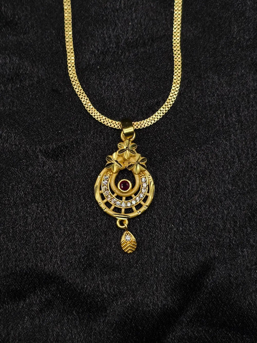 Gold necklace with a pendant on a black background