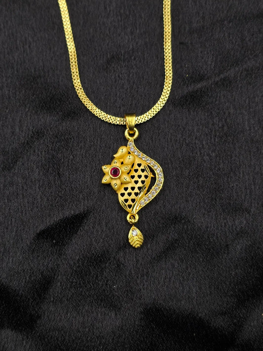 Gold necklace with a pendant on a black background