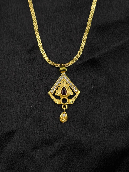 Gold necklace with a diamond-shaped pendant on a black background