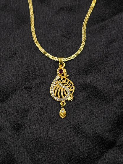 Gold necklace with a decorative pendant on a black fabric background