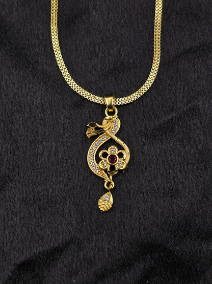 Gold necklace with a decorative pendant on a black background