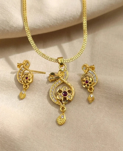 Gold jewelry set with necklace and earrings on a beige fabric background