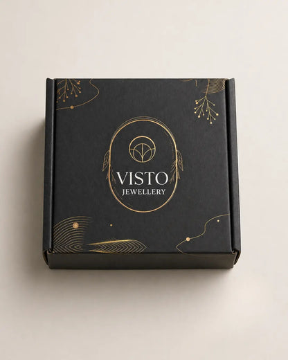 Black box with gold accents and 'Visto Jewellery' branding on a light beige background