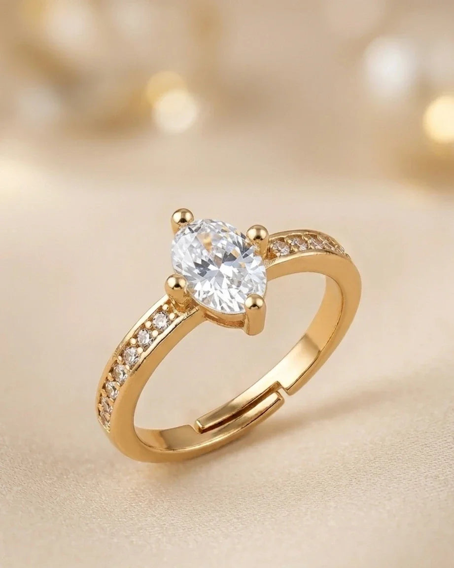 Gold ring with a diamond on a beige background