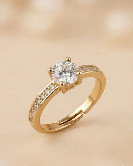 Gold ring with a diamond on a beige background